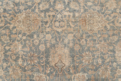 An intricate, blue and beige, Persian-style rug with a floral and vine pattern. The detailed design includes symmetrical motifs and ornate decorations, creating a classic, vintage appearance. The muted colors give this KERMAN RUG, SOUTH EAST PERSIA, 10' 8" X 14' 8" by Ben Soleimani an antique look reminiscent of museum-quality rugs.