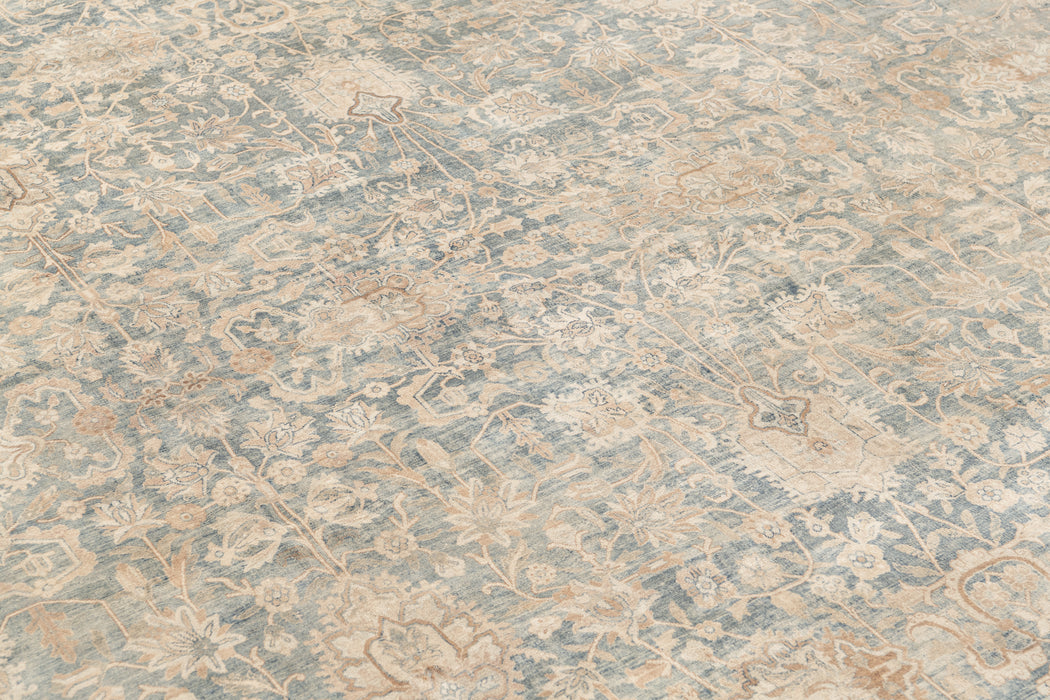 A close-up view of an intricately patterned, antique rug with a blend of light blue, beige, and cream colors. The design features floral motifs and ornate detailing that covers the entire surface, creating a delicate and elegant look reminiscent of museum-quality heirloom rugs: KERMAN RUG, SOUTH EAST PERSIA, 10' 8" X 14' 8" by Ben Soleimani.