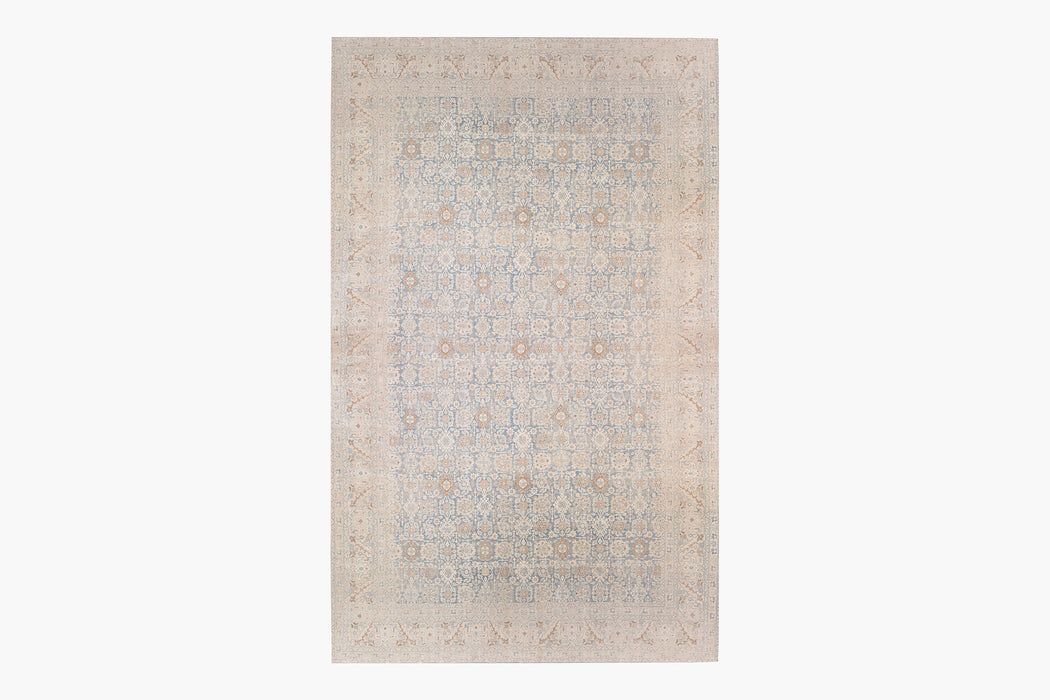 A rectangular TABRIZ RUG, NORTH WEST PERSIA, 11' X 14' with an intricate, symmetrical pattern of geometric shapes and floral motifs. The rug, reminiscent of Ben Soleimani's heirloom-quality pieces, features a muted color palette primarily comprising soft blues, beige, and light brown tones, creating an elegant and subtle design.