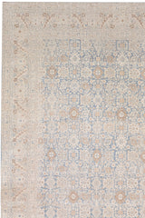 A detailed rug with an intricate floral and geometric pattern in shades of beige, light blue, and cream. Reminiscent of antique rugs, this Ben Soleimani TABRIZ RUG, NORTH WEST PERSIA, 11' X 14' design features a border framing a central field with repeating motifs, giving it an ornate and elegant appearance that's heirloom-quality.
