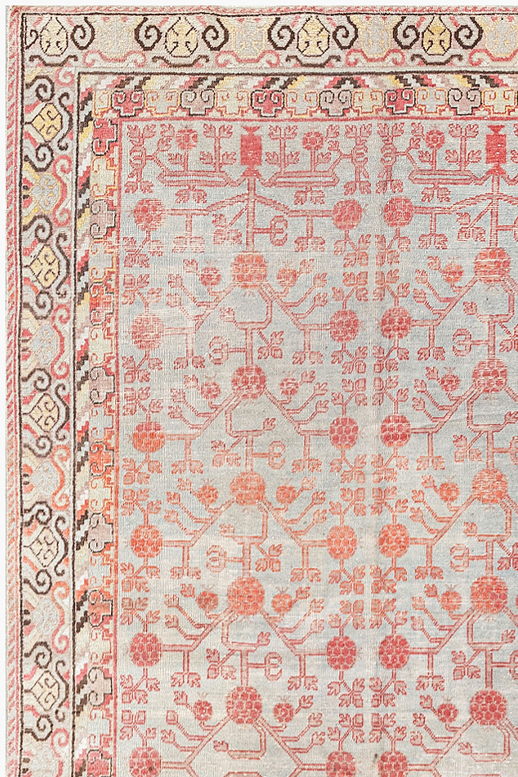 A detailed rectangular KHOTAN RUG, AR30065, EAST TURKESTAN, 5'11" X 11'1" with an intricate design by Ben Soleimani. The rug features a grey background with a red and peach floral and geometric pattern. The border has a multi-colored repeating motif in shades of beige, yellow, red, and black, showcasing heirloom-quality craftsmanship.