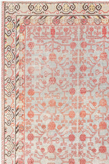 A detailed rectangular KHOTAN RUG, AR30065, EAST TURKESTAN, 5'11" X 11'1" with an intricate design by Ben Soleimani. The rug features a grey background with a red and peach floral and geometric pattern. The border has a multi-colored repeating motif in shades of beige, yellow, red, and black, showcasing heirloom-quality craftsmanship.