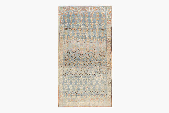 A rectangular MALAYIR RUG, AR30045/15857, WEST PERSIA, 4'4" X 6'9" by Ben Soleimani with an intricate geometric pattern, featuring a gradient of colors from beige at the bottom to various shades of blue towards the top. Reminiscent of antique heirloom rugs, it has a mix of symmetrical and abstract designs, framed by a detailed border.