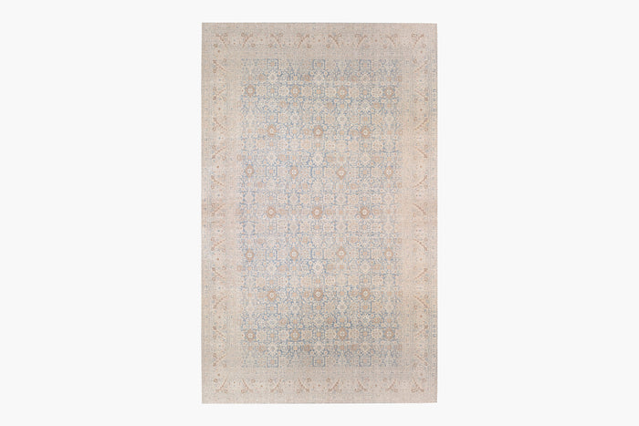 A rectangular TABRIZ RUG, NORTH WEST PERSIA, 11' X 14' with an intricate, symmetrical pattern of geometric shapes and floral motifs. The rug, reminiscent of Ben Soleimani's heirloom-quality pieces, features a muted color palette primarily comprising soft blues, beige, and light brown tones, creating an elegant and subtle design.