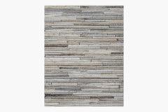 Tall rectangular piece of wall art featuring a horizontal pattern of stacked wooden planks in varying shades of gray and brown. The wood grains and textures are visible, adding a rustic, natural feel to the design, similar to the artisanal quality found in the Ben Soleimani Ladro Hide – Grey collection.